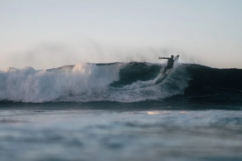 A surfer going up the face of a wave