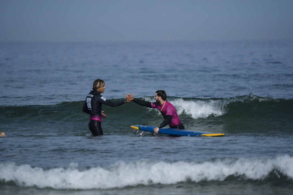A student giving five to our instructor after an epic wave in Pantin, Galicia