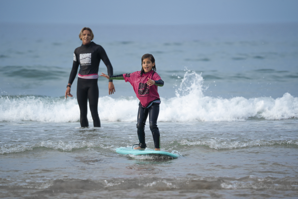 A junior student having a lot of fun while riding a wave